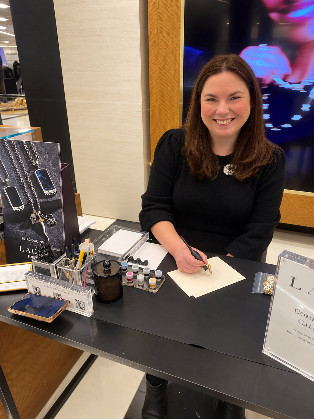 Live calligraphy artist personalizing handwritten greeting cards at a Lagos Jewelry event in New York City.