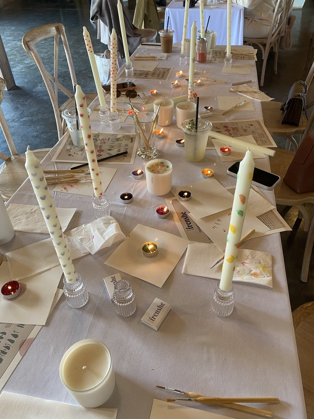 Hand-painted taper candle with decorative ribbon designs created during the Being Frenshe candle painting workshop.
