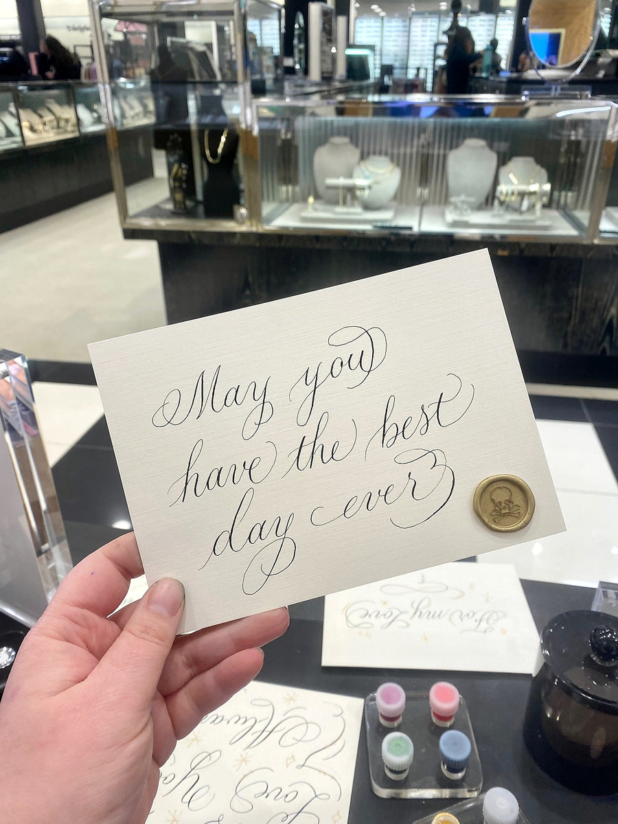 Elegant handwritten calligraphy on a personalized greeting card featuring a gold wax seal, created by The Poppy Pen for a LAGOS Jewelry live event in NYC.