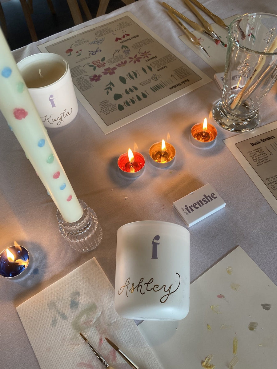 Personalized Being Frenshe candles featuring hand-calligraphed guest names at an influencer wellness retreat.
