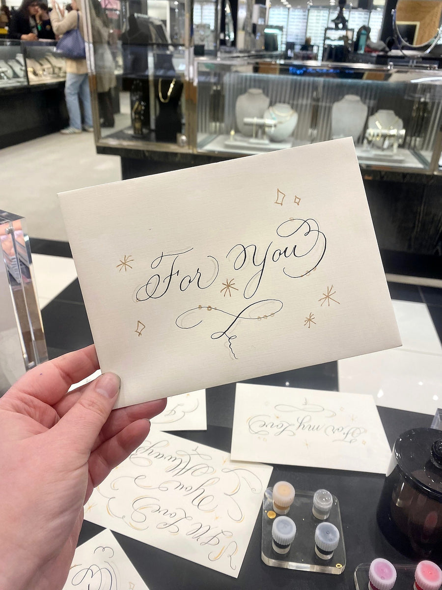 Romantic “For My Love” greeting card featuring delicate handwritten calligraphy and gold embellishments, personalized at a LAGOS Jewelry event in NYC.
