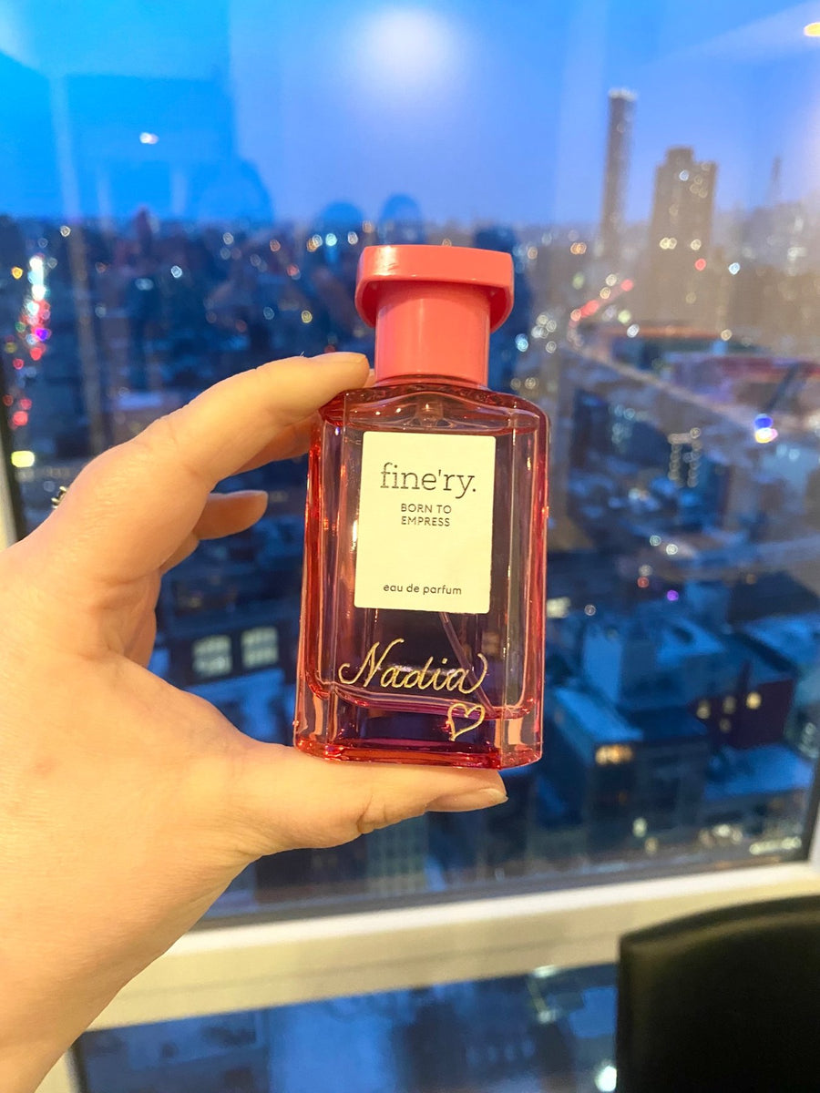 Pink Fine'ry perfume bottle with a guest's name and heart in gold script, showcasing custom fragrance engraving by NYC engraver The Poppy Pen.