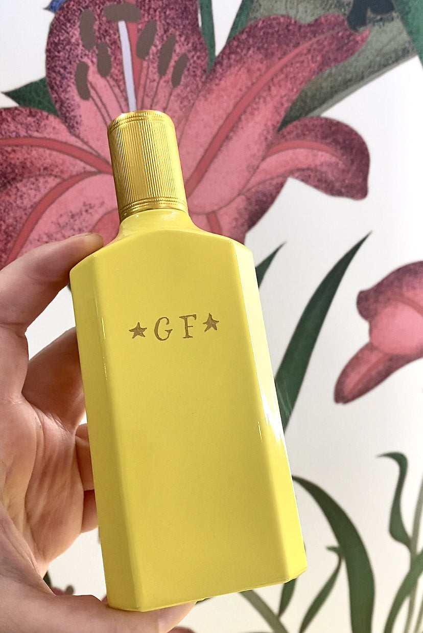 Gucci yellow perfume bottle engraved with GF initials and decorative stars by a New York City live engraver.