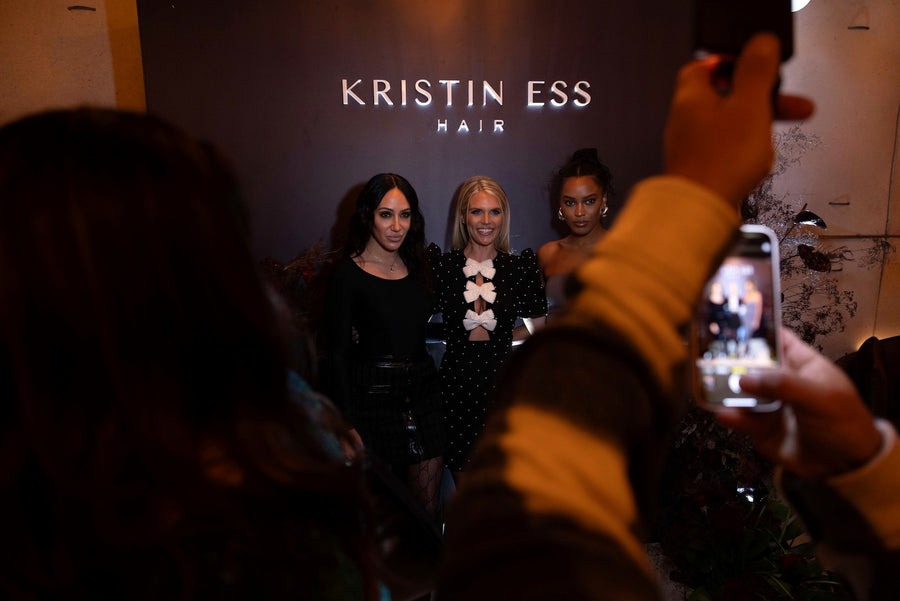 Kristin Ess NYC brand activation featuring personalized leather styling cases with custom gold lettering.