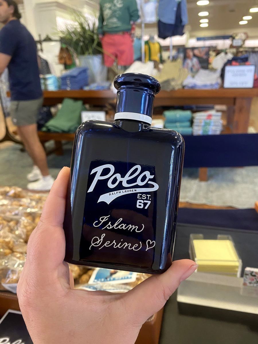Close-up of custom hand engraving on a Polo Ralph Lauren Polo 67 fragrance bottle for a New York City retail event.