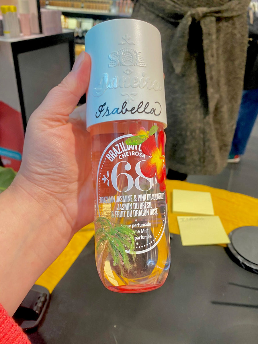 : Sol de Janeiro Cheirosa 68 fragrance mist with personalized hand lettering and tropical flower painting by New York event artist The Poppy Pen.