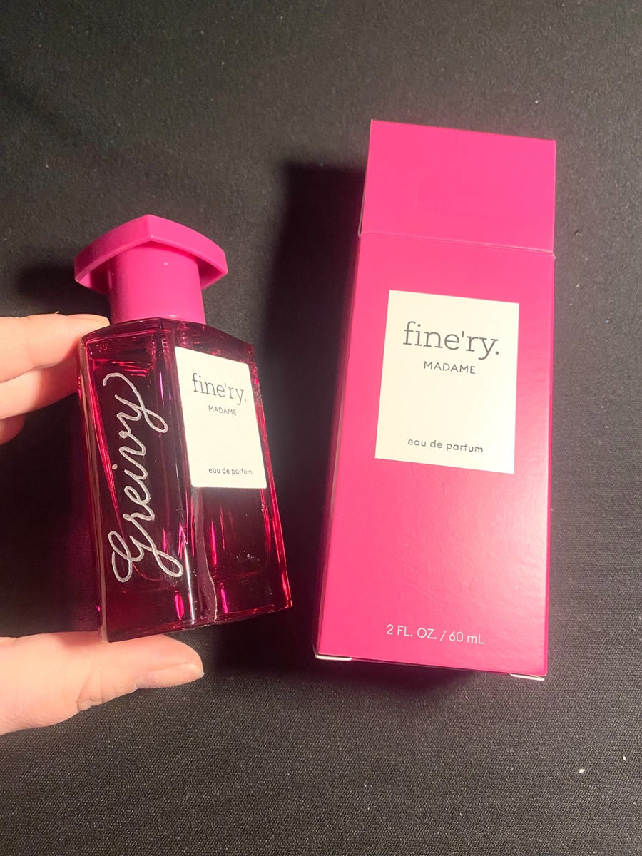 Fine'ry Madame fragrance bottle with custom silver script engraving beside its pink packaging, personalized by NYC calligrapher The Poppy Pen.