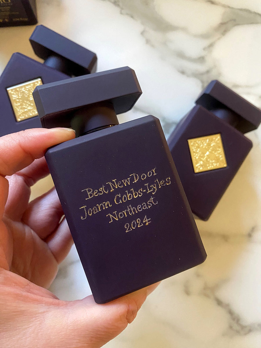Purple Initio Parfums Privés fragrance bottle featuring a custom engraved award title, recipient's name, and year.