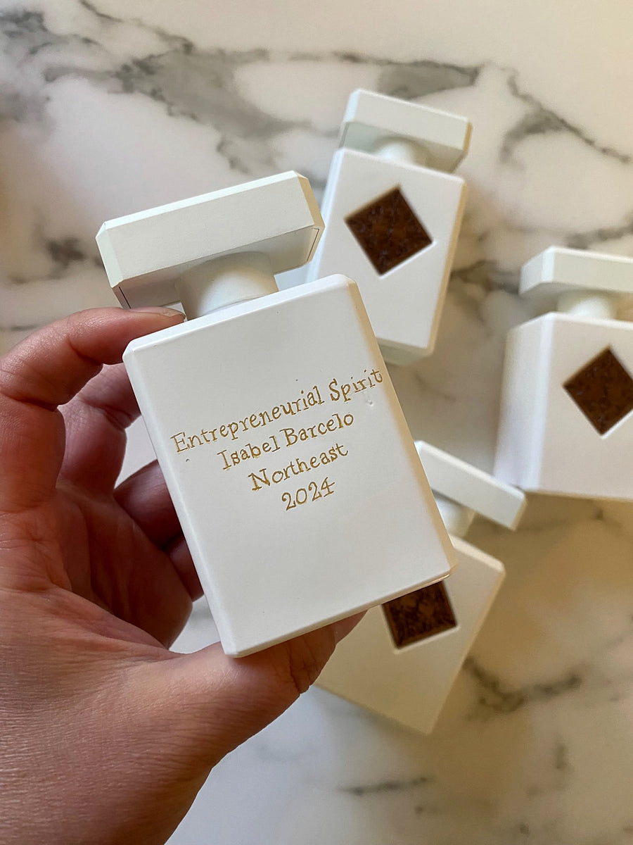 White Initio Parfums Privés perfume bottle with custom engraved Entrepreneurial Spirit award lettering.